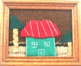 Artisan wall hanging with green house